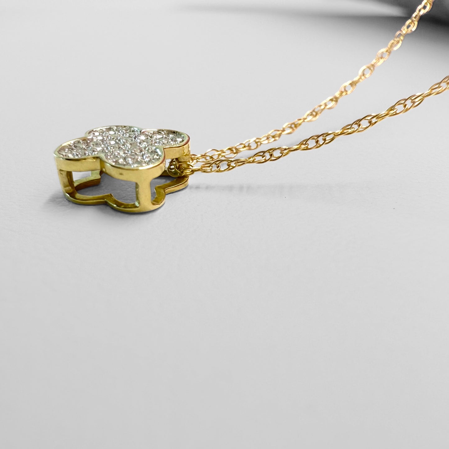 Side view of clover pendant and close up of chain details