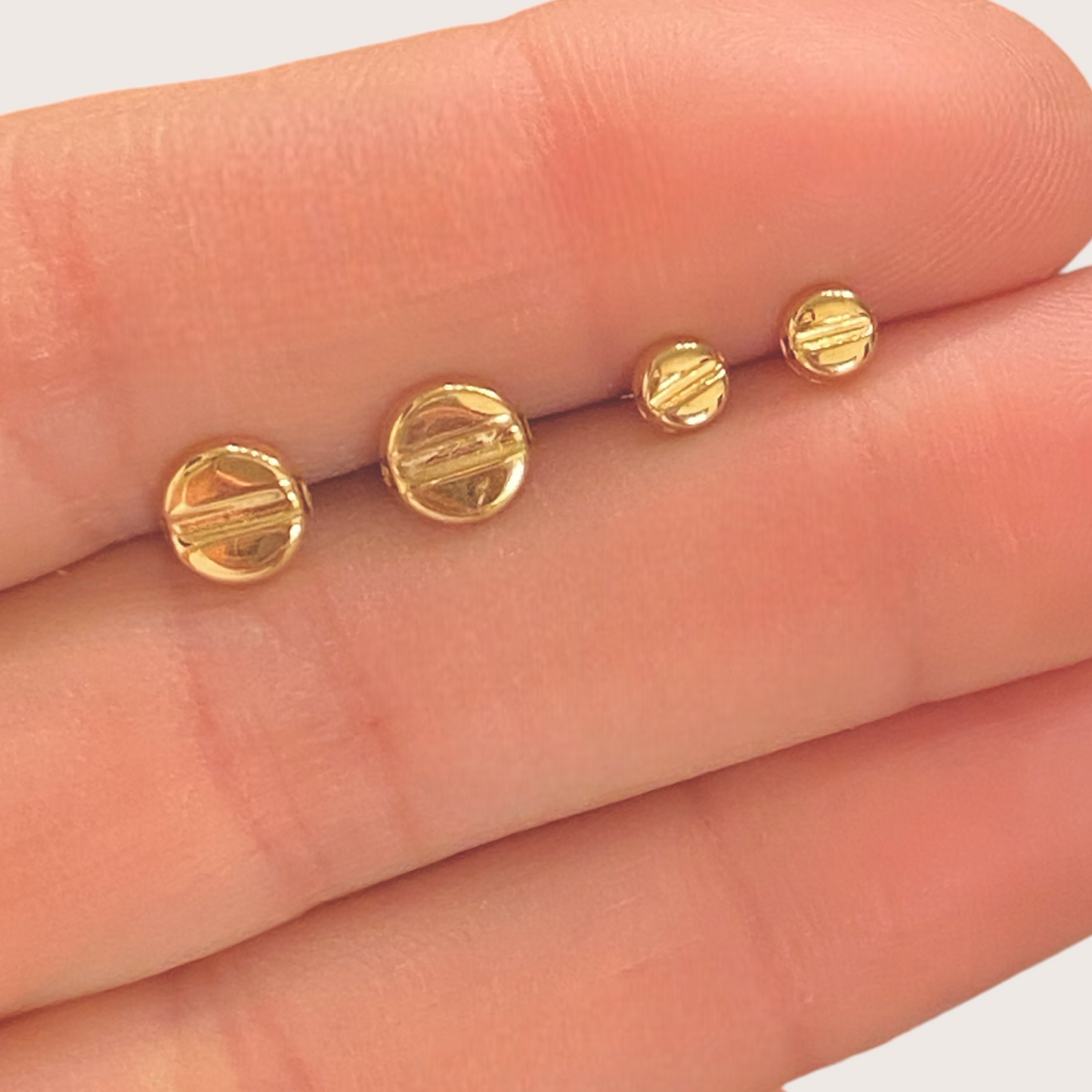 Close up of 14K Gold Love Stud Earrings