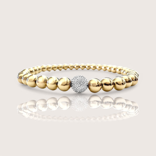 Unparalleled luxury with this exquisite 5mm 14K Yellow Gold Beaded Ball Bracelet with a Single White Gold Diamond Ball. Crafted from premium 14K Gold and adorned with genuine diamond accents exuding sophistication and elegance.