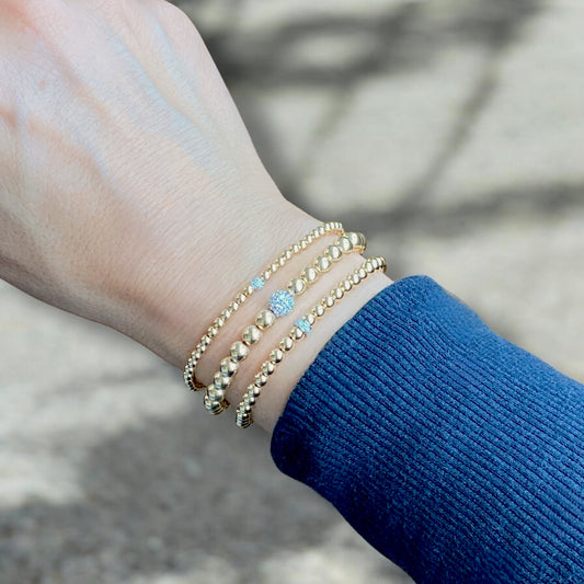 14K gold 4mm diamond bracelet stacked with fine jewelry — stackable gold beaded bracelet by Ashley Nicole Jewelry