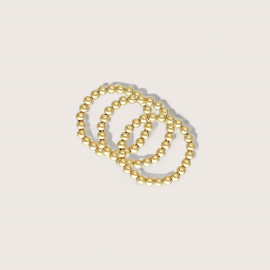 Gold Beaded Rings will add some bubbly fun to your everyday style for a touch of simple elegance. Crafted in a 14K gold finish, these stretch rings are trendy, fun, and waterproof for long-lasting wear. Upgrade your look with our exclusive non-tarnishing gold beads.