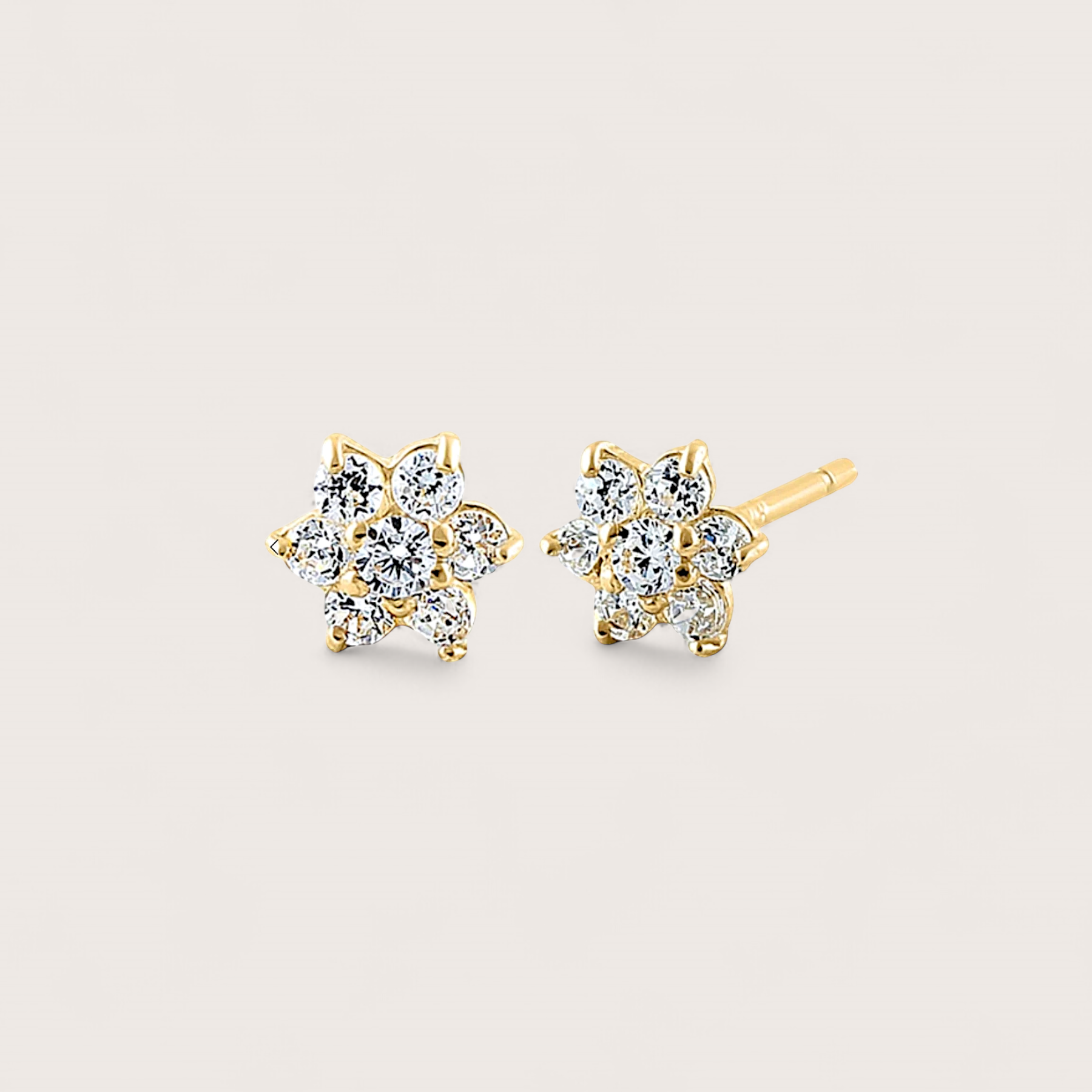 Close up of 14K yellow gold diamond earrings