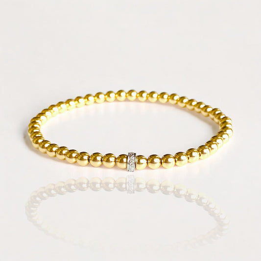 Premium 14K Gold Beads: Each 4mm  bead is crafted from high-quality 14K yellow gold, offering a radiant and durable finish.
Single Diamond Accent: The bracelet is adorned with one diamond-accented Roundel, adding a touch of luxury and brilliance.
Elastic Stretch Fit: Designed with an elastic cord, this bracelet provides a comfortable and flexible fit for various wrist sizes.
Handcrafted Quality: Meticulously handmade to ensure exceptional craftsmanship and attention to detail.