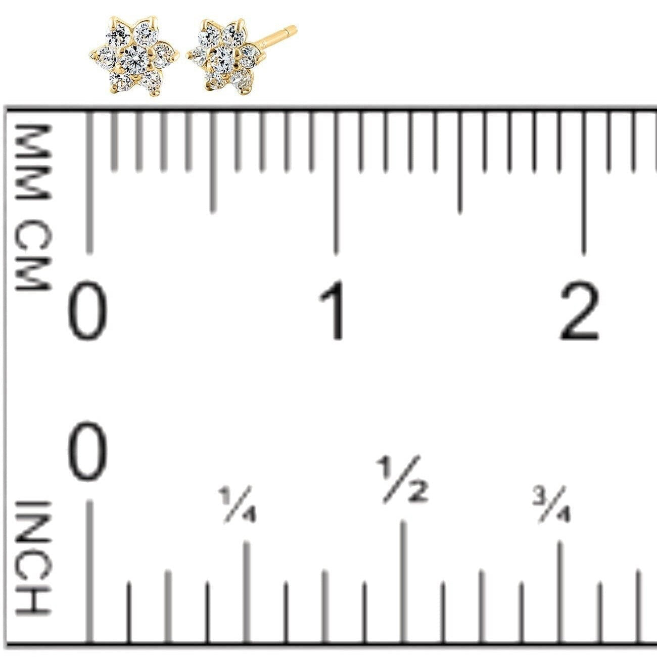 Close up of 14K yellow gold diamond earrings next to a ruler for size guide