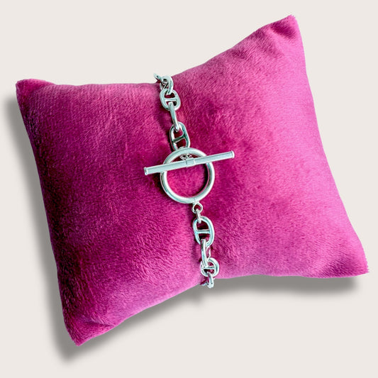 Close-up of Sterling Silver Anchor Chain Links with Toggle Clasp on Pink Pillow