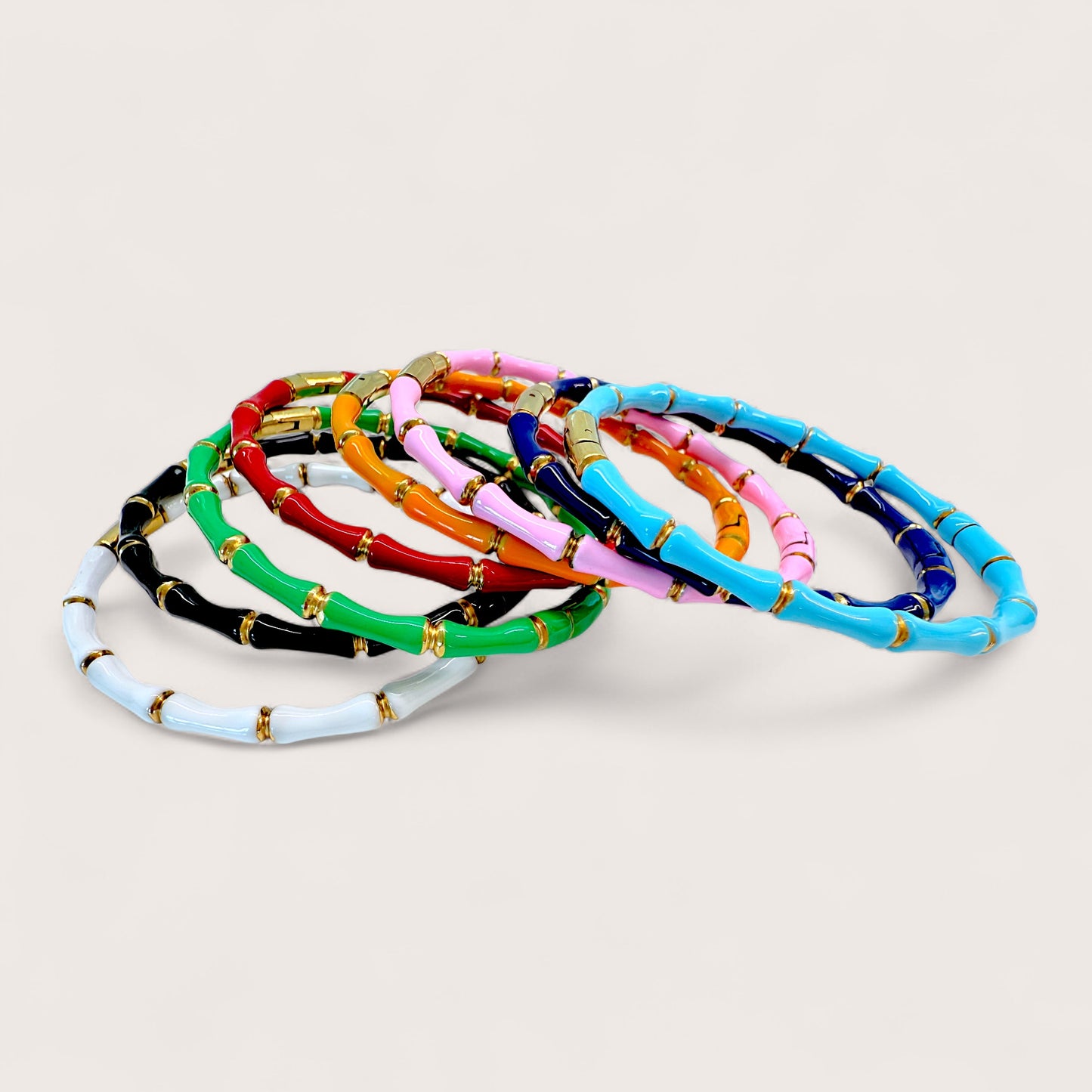 Set of colorful bracelets on a light gray background