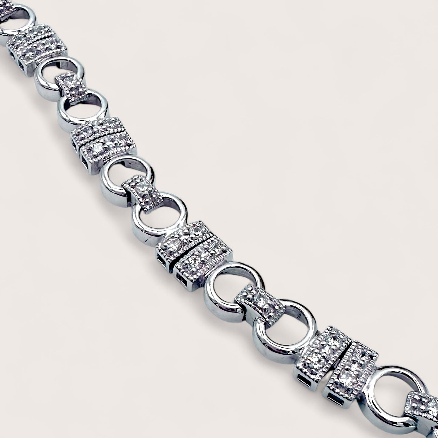 Silver bracelet with diamond accents on a light gray background