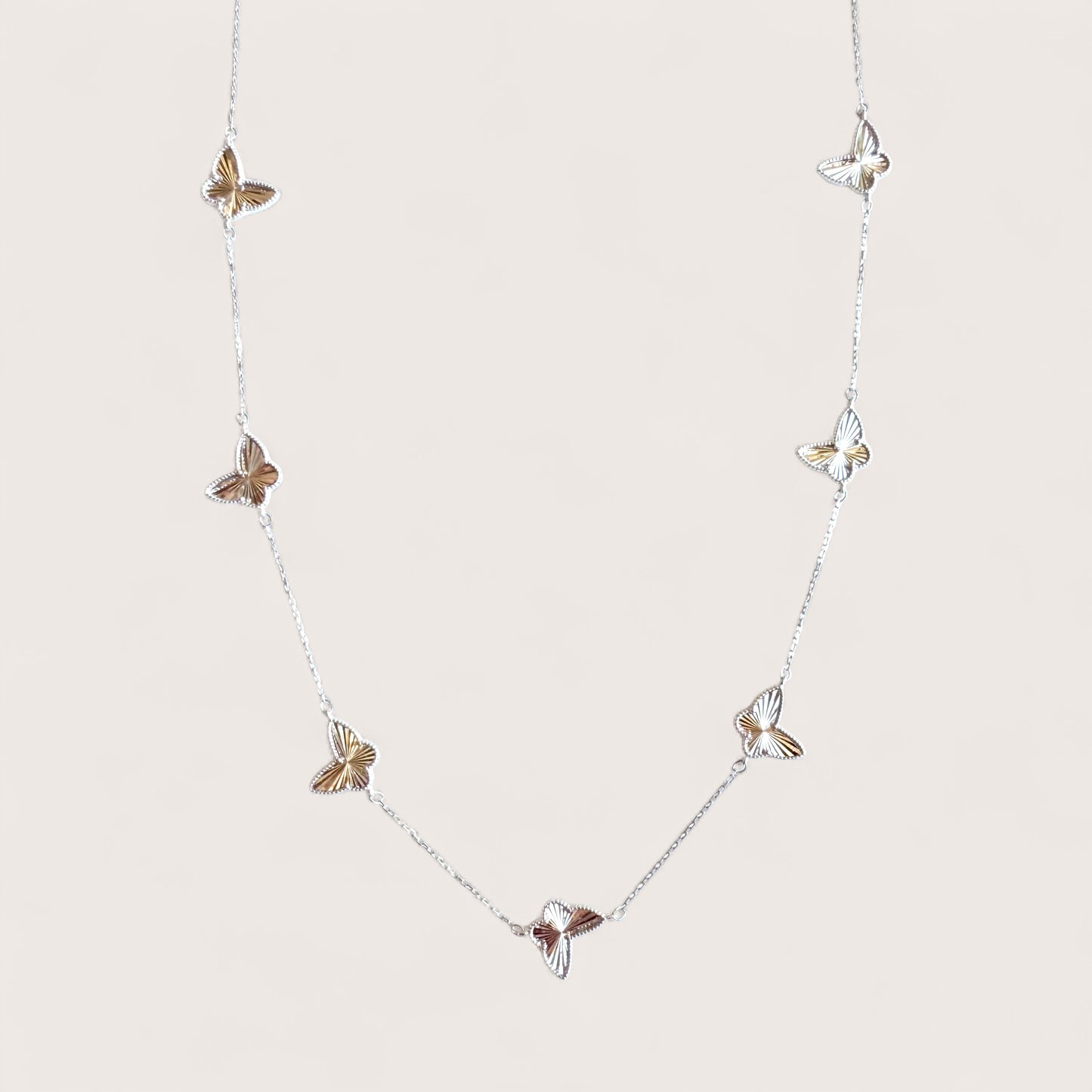 Sterling silver 7 motif butterfly charm station necklace with diamond-cut faceted detail