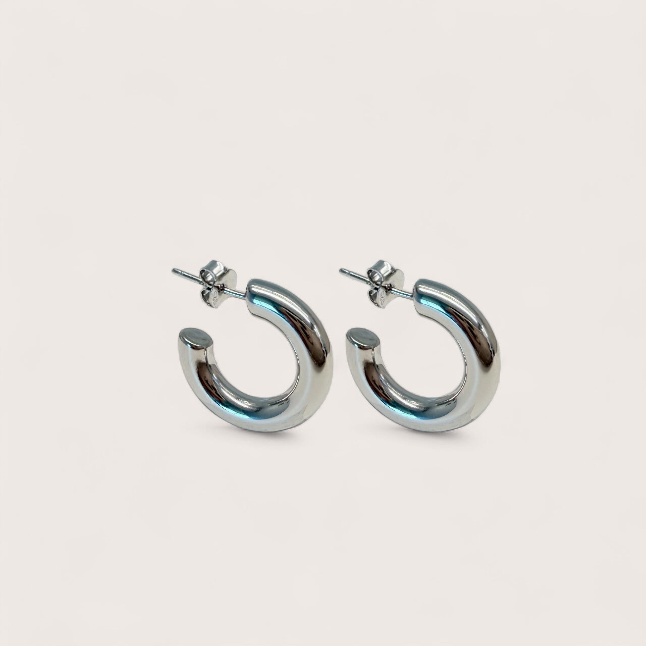 Silver hoop earrings on a light gray background