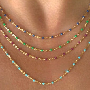 Stack of gold enamel bead necklace in multiple colors