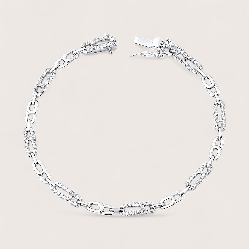 Silver bracelet with clear stones on a light gray background