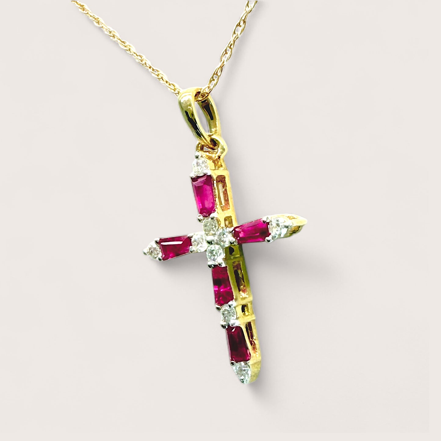 Close up angle view 14K Yellow Gold Diamond and Ruby cross pendant