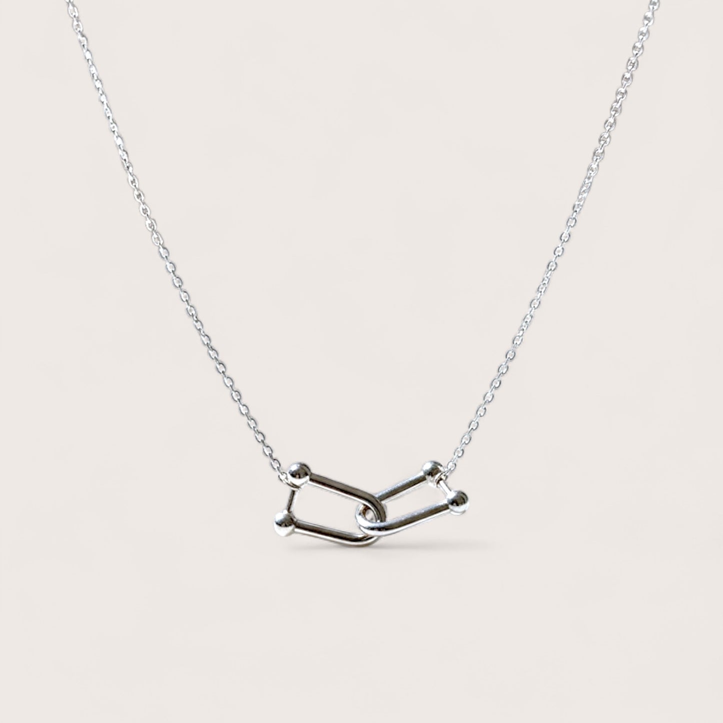 Silver necklace with a unique interlocking U link charms