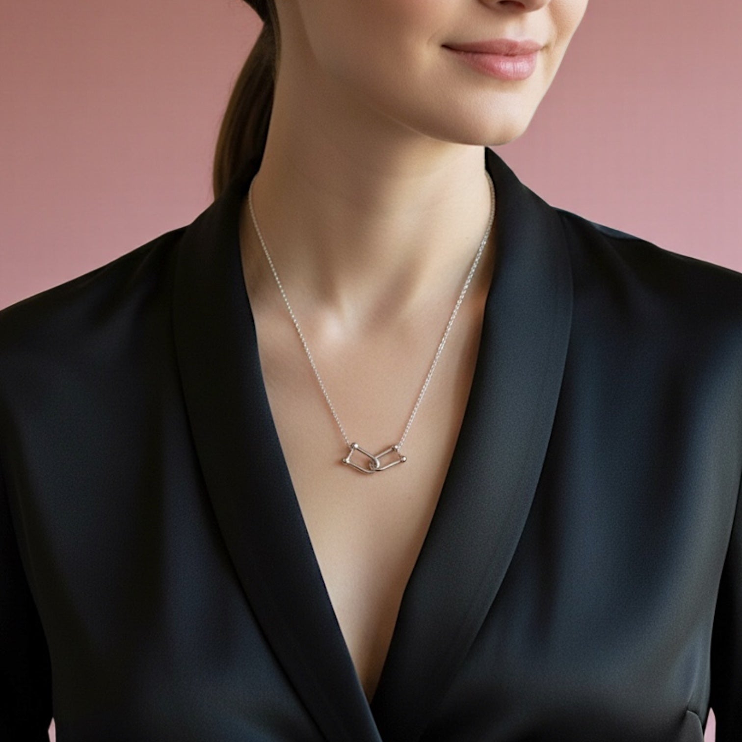 Woman wearing a sterling silver interlocking u-link  necklace.