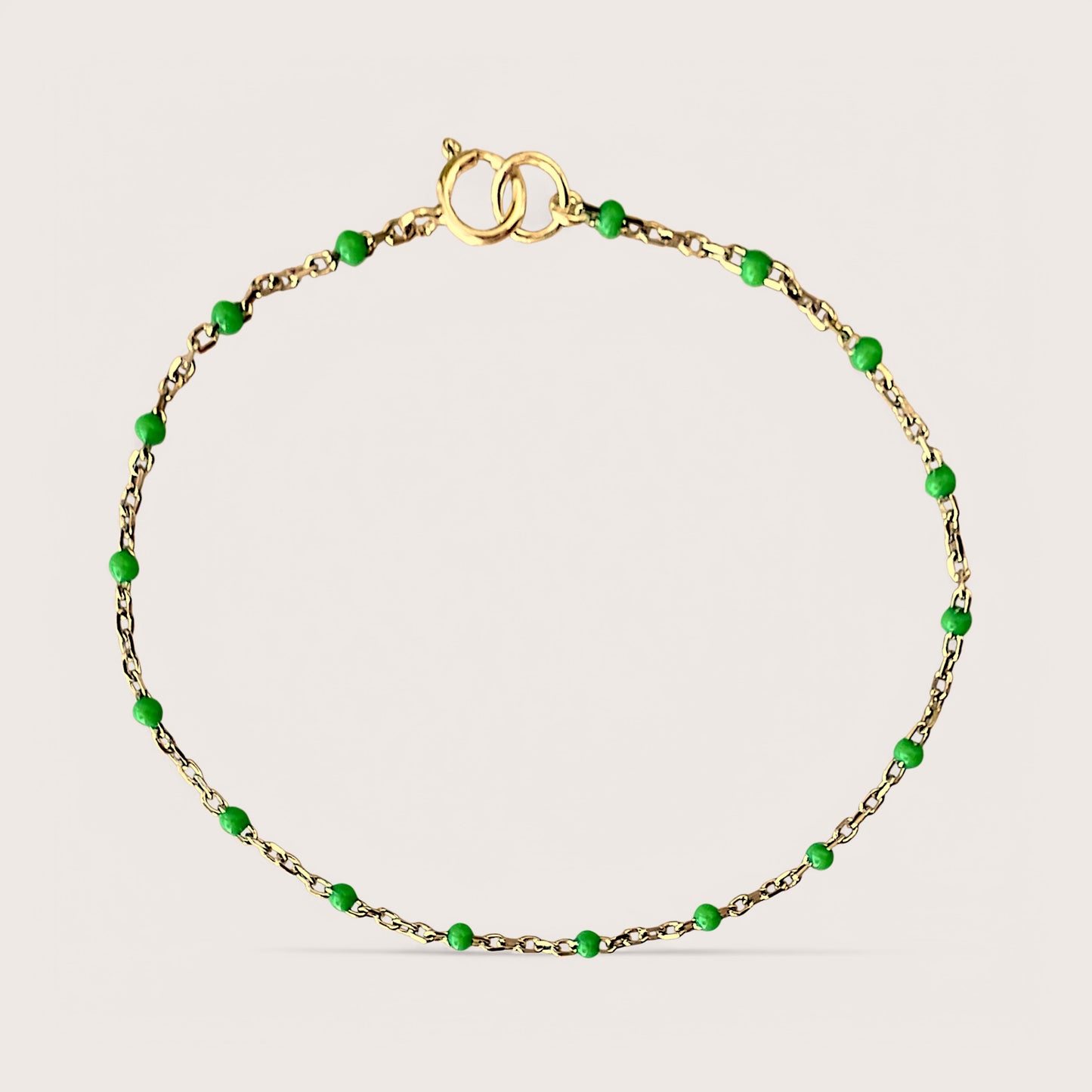 Elegant. Affordable. High-Quality. Introducing our Gold Enamel Bracelet, a stunning design. Crafted from 14K gold filled materials, this bracelet features emerald-colored enamel beads stationed along a delicate chain, offering a minimalist yet sophisticated look. See Size Chart for Help with Bracelet Sizing! 