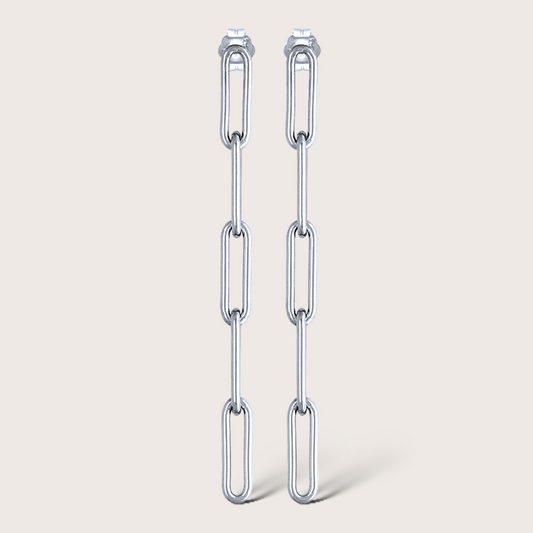 A pair of gold paperclip earrings with five links each, displayed against a white background.