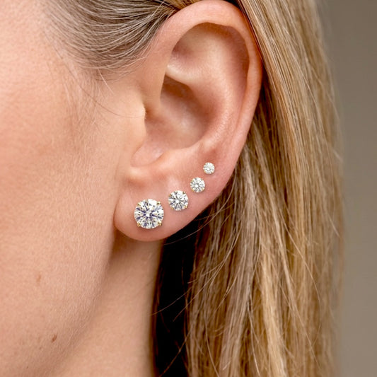 Side view of real 14K solid gold round diamond studs in premium VS-VVS diamond clarity.Model wearing earrings for size visual - from small to large 0.23 ctw (3mm), 0.54 ctw (4mm), 1.04 ctw (5mm), 1.86 ctw (6mm)