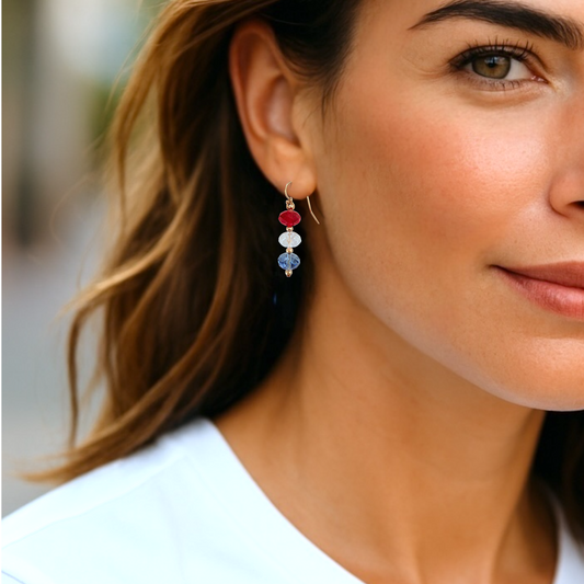 Close-up of a woman wearing colorful earrings with a blurred background