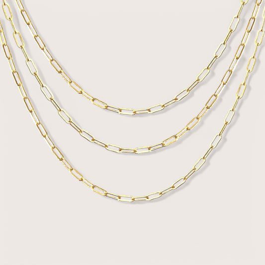 Elegant Small Link Paperclip Chains. Crafted from 14K yellow gold filled, these versatile chains are ideal for everyday wear and can be effortlessly layered. These on-trend necklaces boast a timeless design that adds a touch of elegance to any outfit. Whether you’re gifting them or simply want to enhance your own style, these chains are sure to impress.