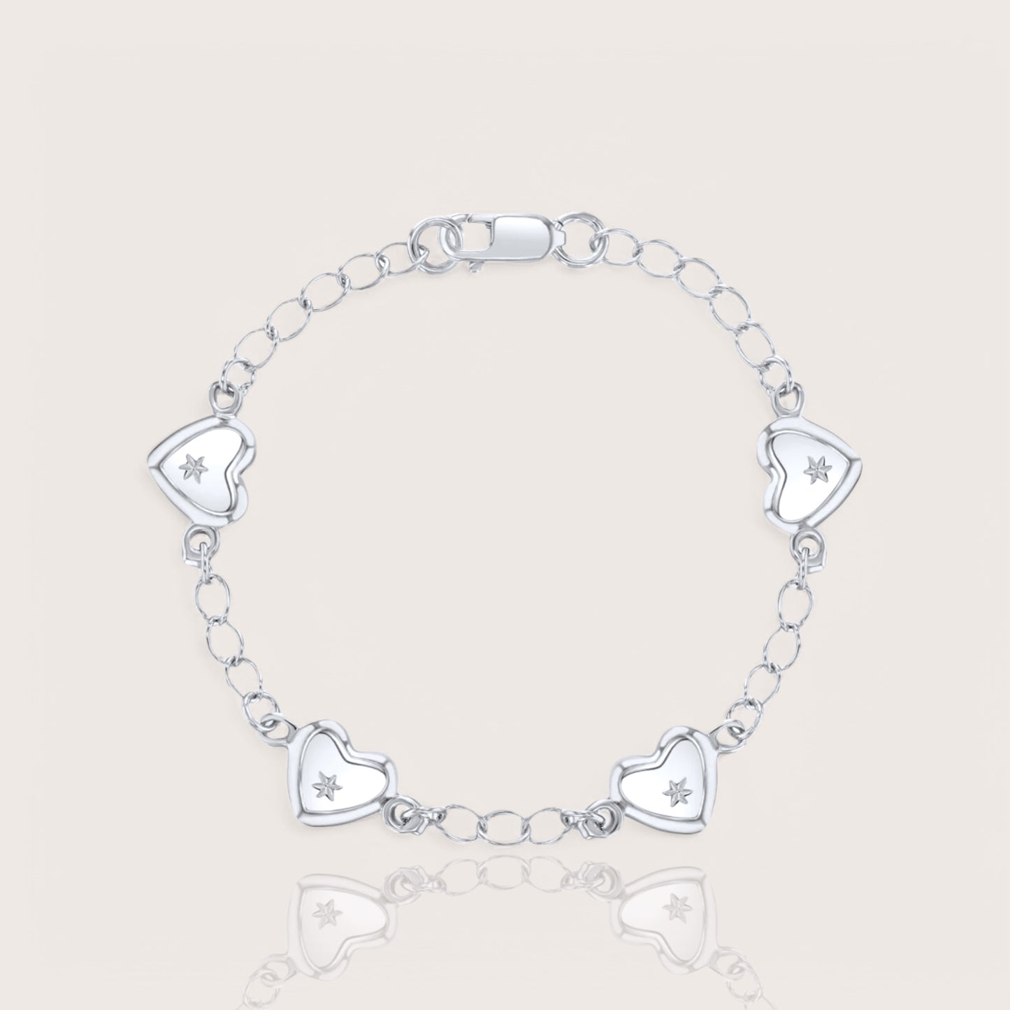 A silver charm bracelet for babies or toddlers featuring a chain design with five heart charms, each adorned with a star embellishment.