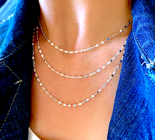 925 sterling silver mirror link chain necklaces with oval sequin discs, layered in 3 lengths on a model