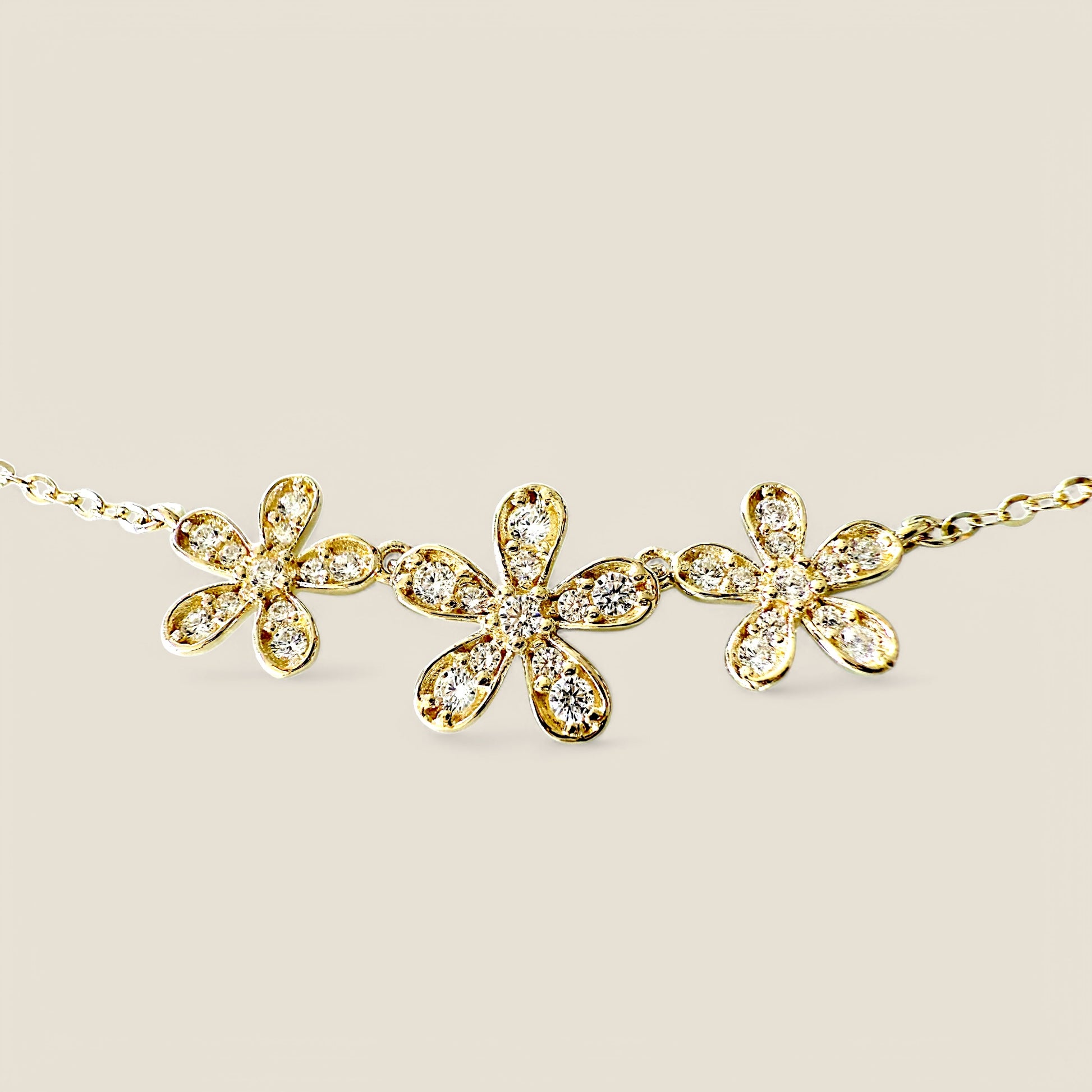 Close up Solid 14K gold necklace with three connected flower pendant and CZ centers