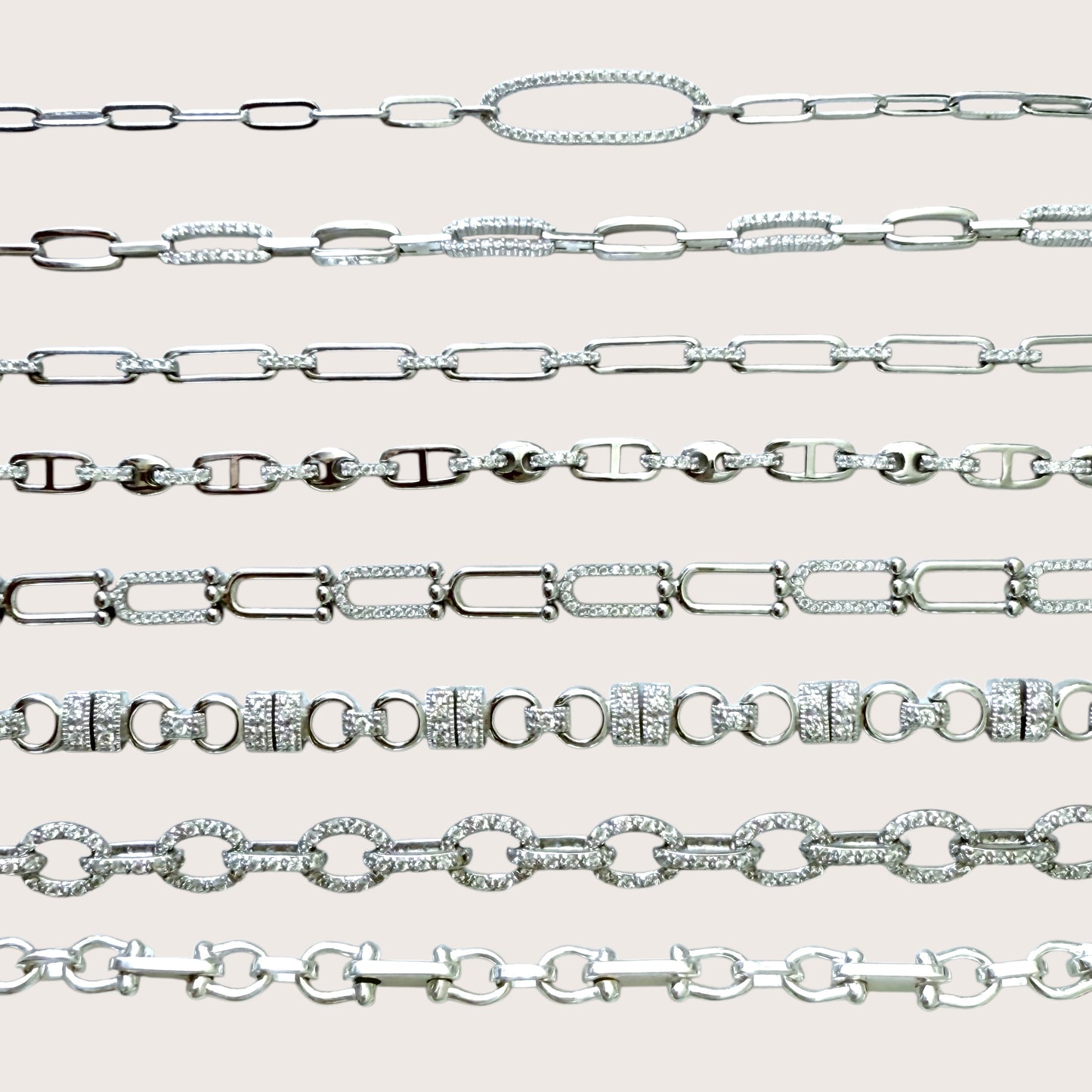 Collection of silver chain bracelets on a light gray background