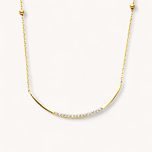 Gold necklace with small diamonds on a white background