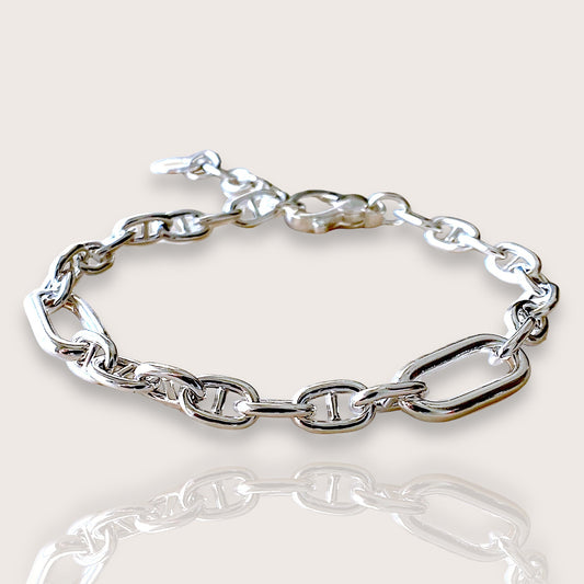 Silver chain bracelet on a light beige background