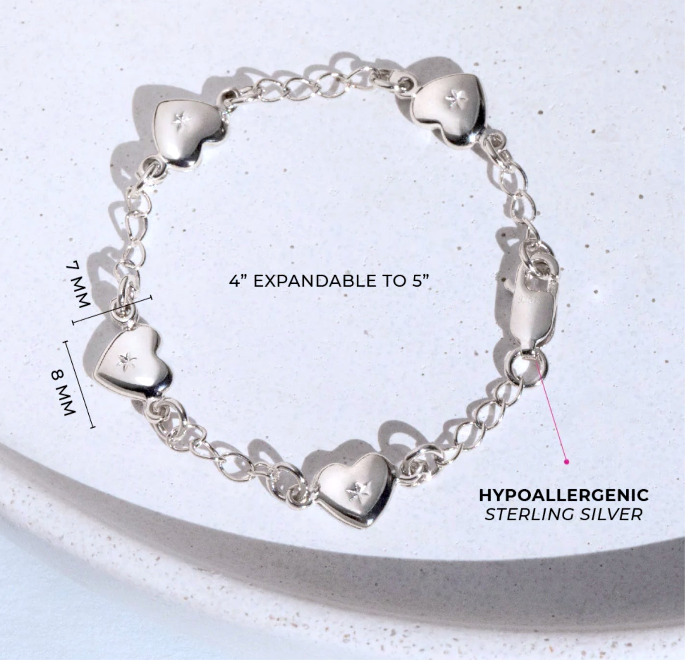 close up of sterling silver heart bracelet showing charms dimensions and clasp on white background