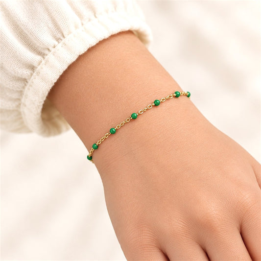 Emerald green enamel and 14K gold-filled bracelet on a child-sized wrist