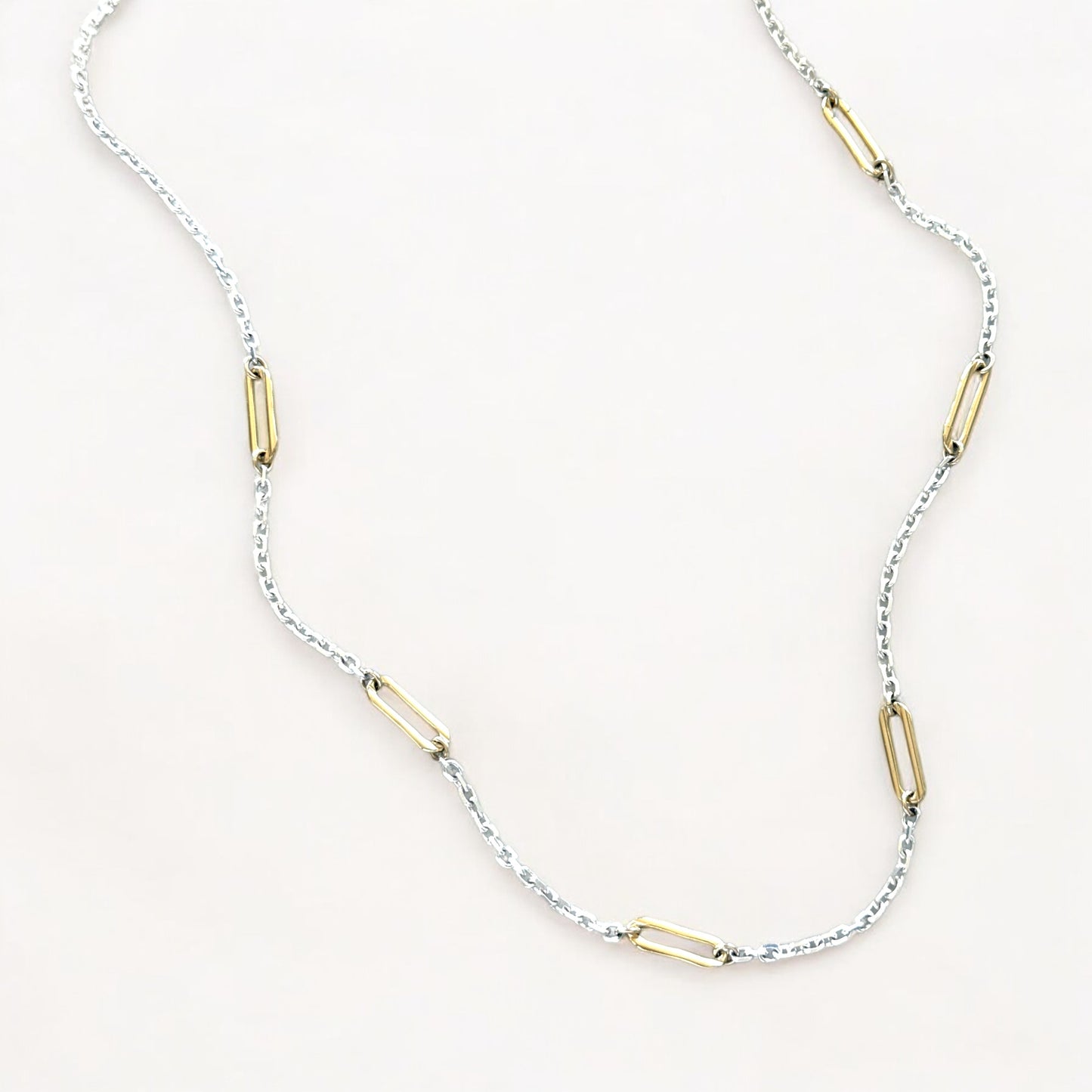 Close-up of 2mm diamond-cut sterling silver cable chain with evenly spaced 14K gold-filled paperclip links