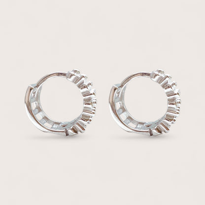 side view of hinged silver huggie hoop earrings