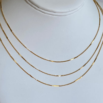 14K Gold Filled Bar Station Chain Necklace on display showing dainty dapped bar links layered with other gold chains.