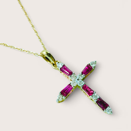 Gold necklace with a cross-shaped pendant featuring ruby and diamond gemstones