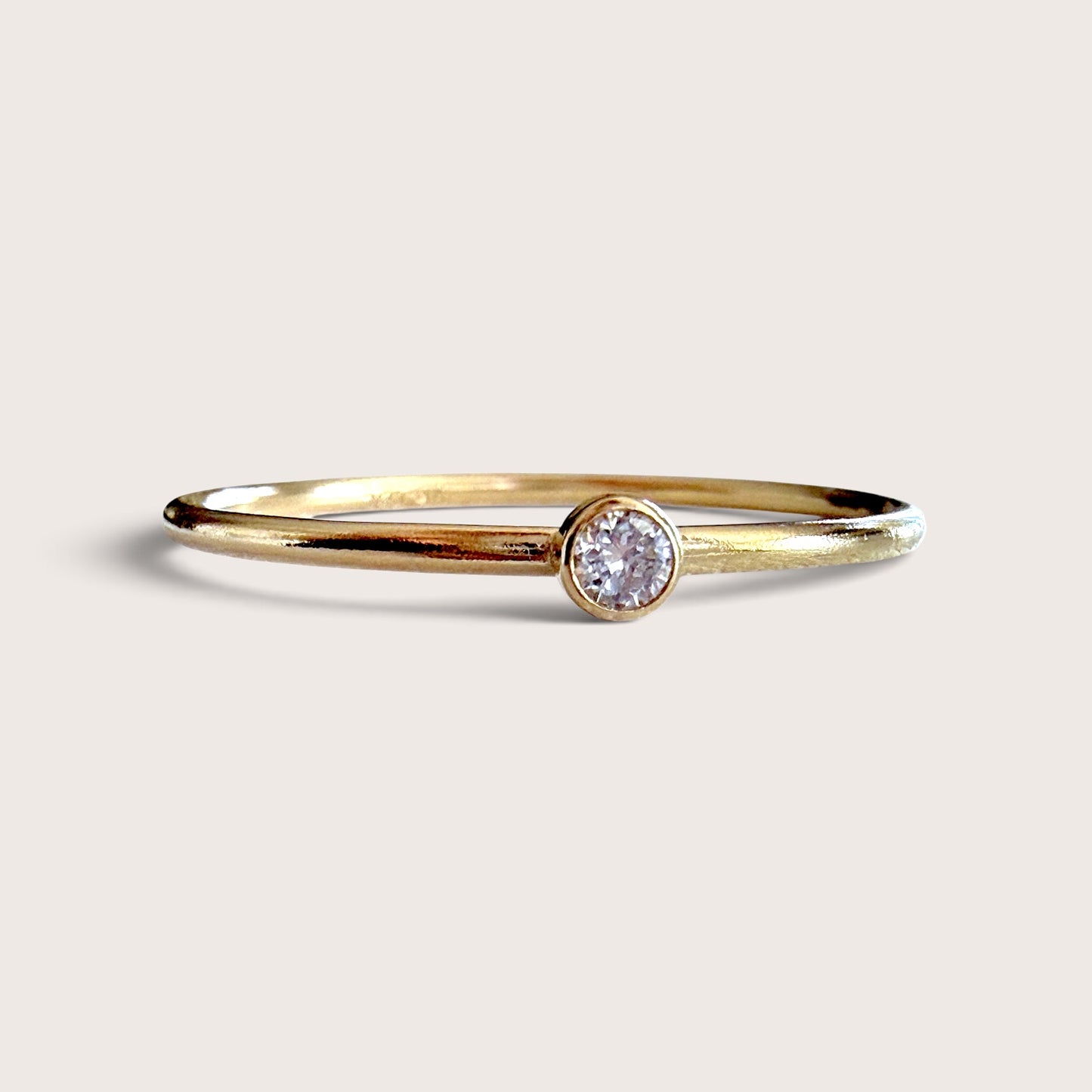 Macro close-up front view of brilliant cut VS DEF 2.0mm lab grown diamond set in smooth 14K gold filled bezel | Ashley Nicole Jewelry