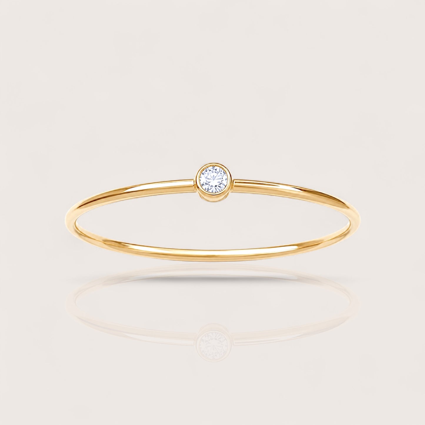 Detailed close-up shot highlighting the high-polish finish and flush setting of the 14K gold filled lab diamond bezel ring