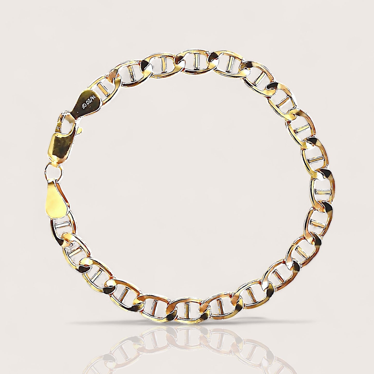 High polish 14k gold filled flat mariner anchor link chain bracelet lying flat on a minimalist surface by Ashley Nicole Jewelry⁠