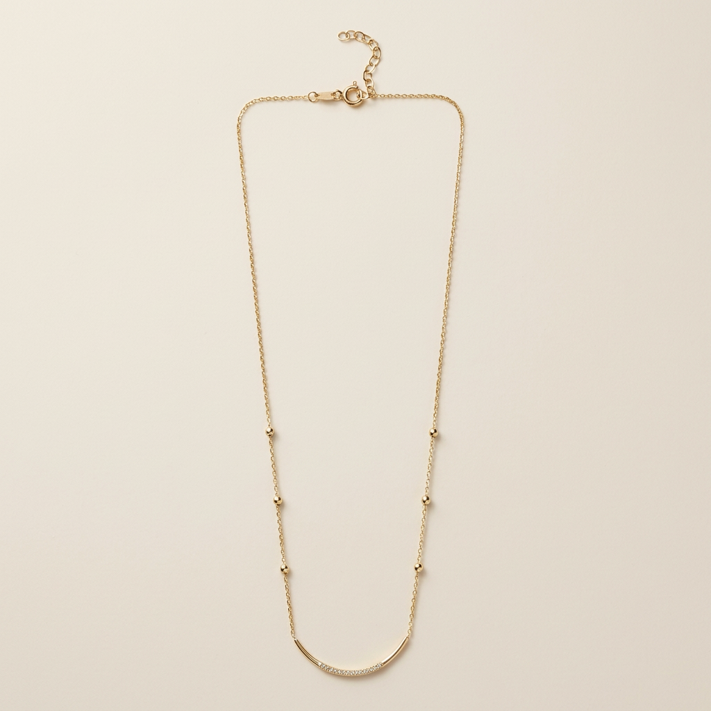 Full gold satellite necklace showing the curved CZ bar, six bead stations, spring-ring clasp, and extension chain