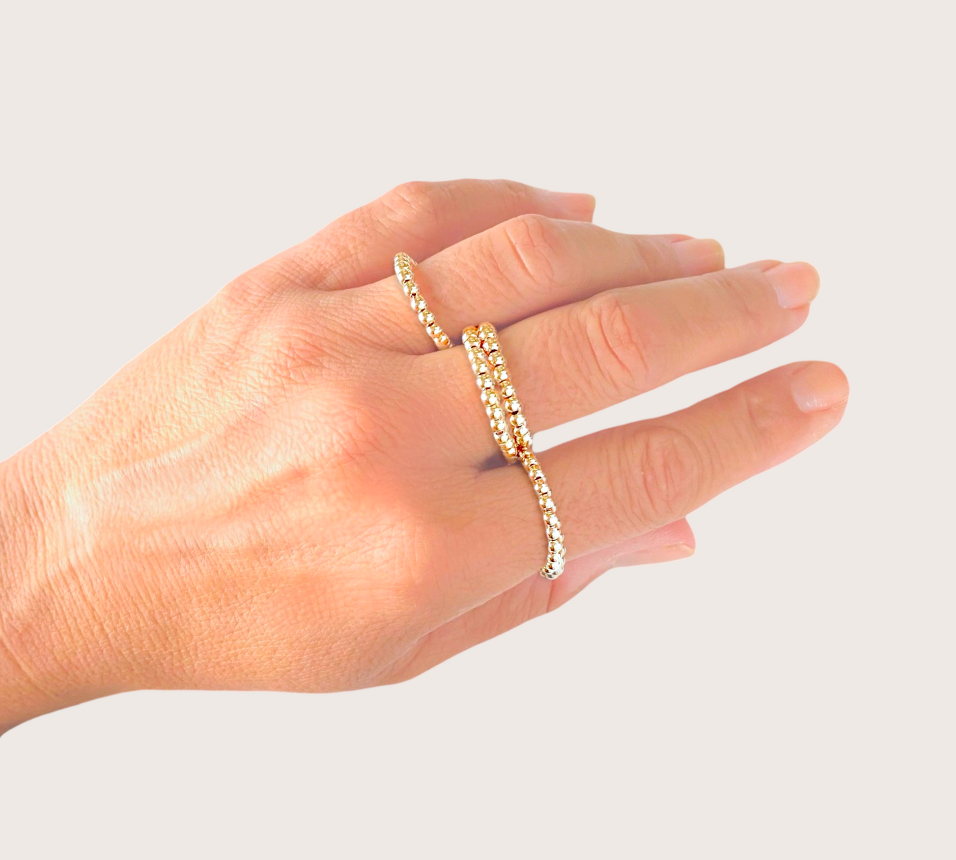 Model wearing stacked 14k gold filled 3mm Gold Beaded Rings 