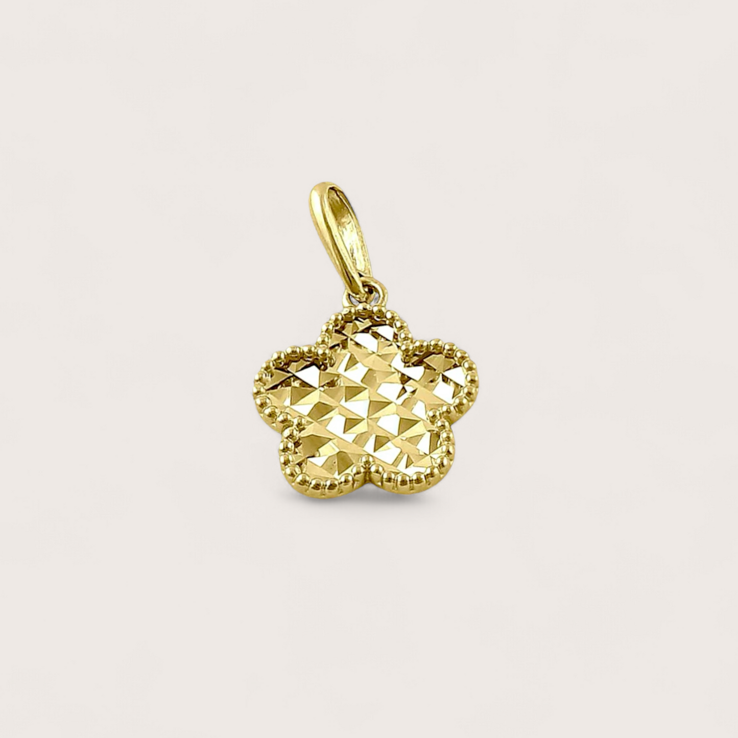 Close up of Solid 14k Gold Clover Pendant with Diamond Cut pattern on front side