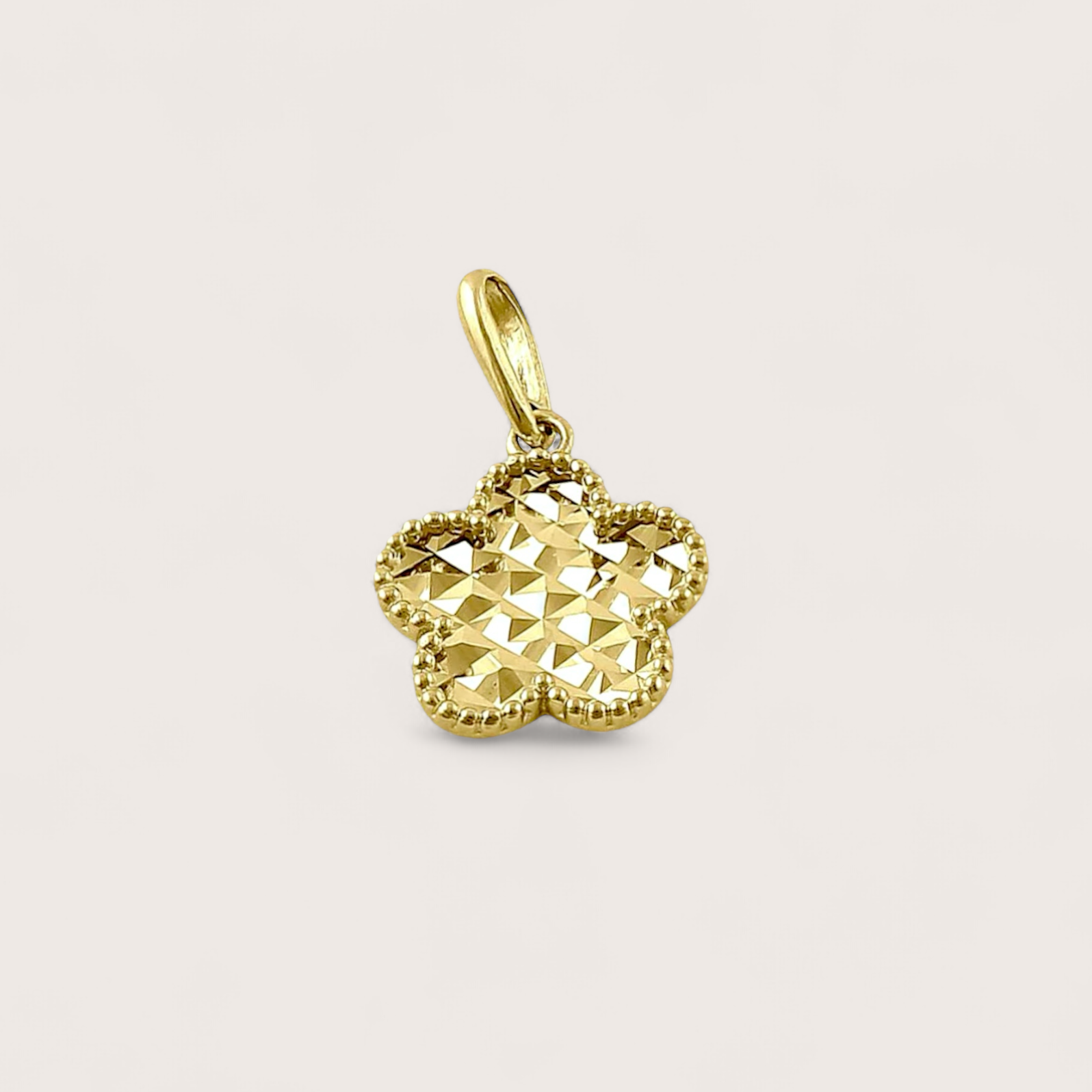 Close up of Solid 14k Gold Clover Pendant with Diamond Cut pattern on front side