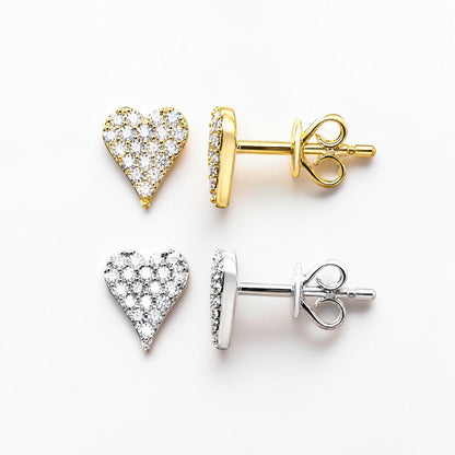14k solid gold heart-shaped pavé stud earrings shown on a clean white background, one in yellow gold and one in silver-tone metal, each displayed with the back post view.