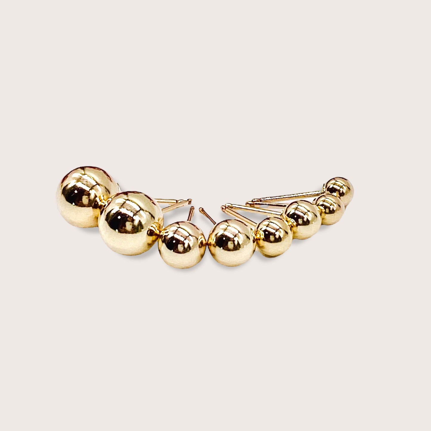The full size range of 14K gold-filled ball stud earrings from3mm to 8mm displayed in order on a clean white background.