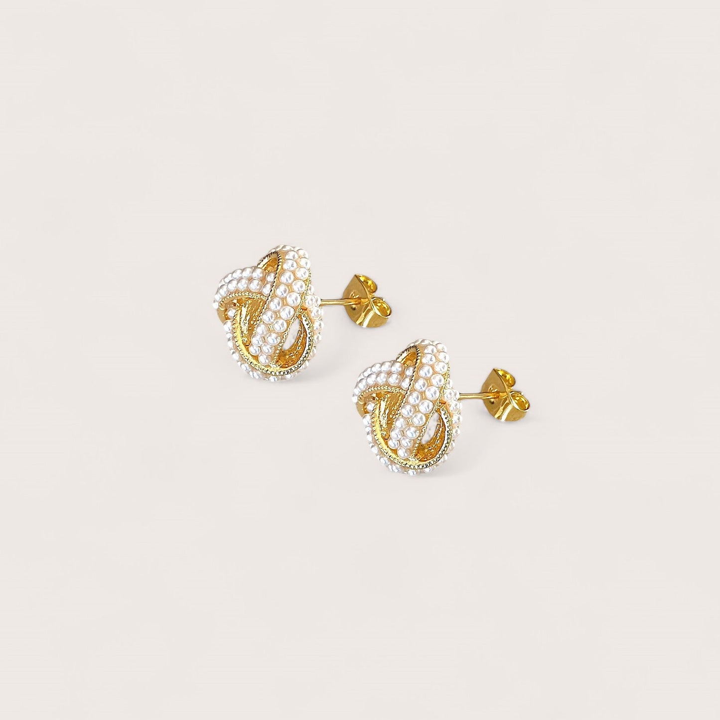 Close-up structural view of the 14mm pearl love knot earrings showing the secure push-back closure.