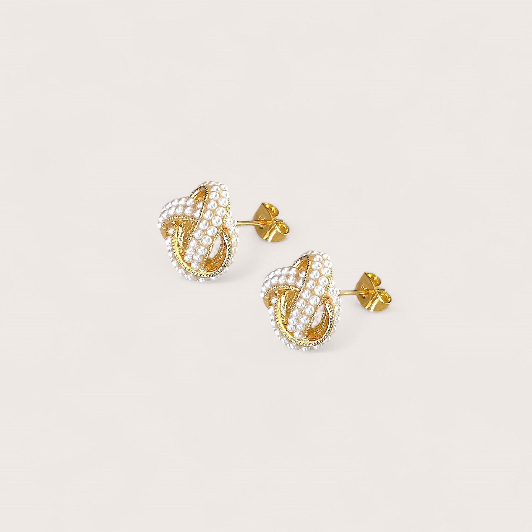 Close-up structural view of the 14mm pearl love knot earrings showing the secure push-back closure.