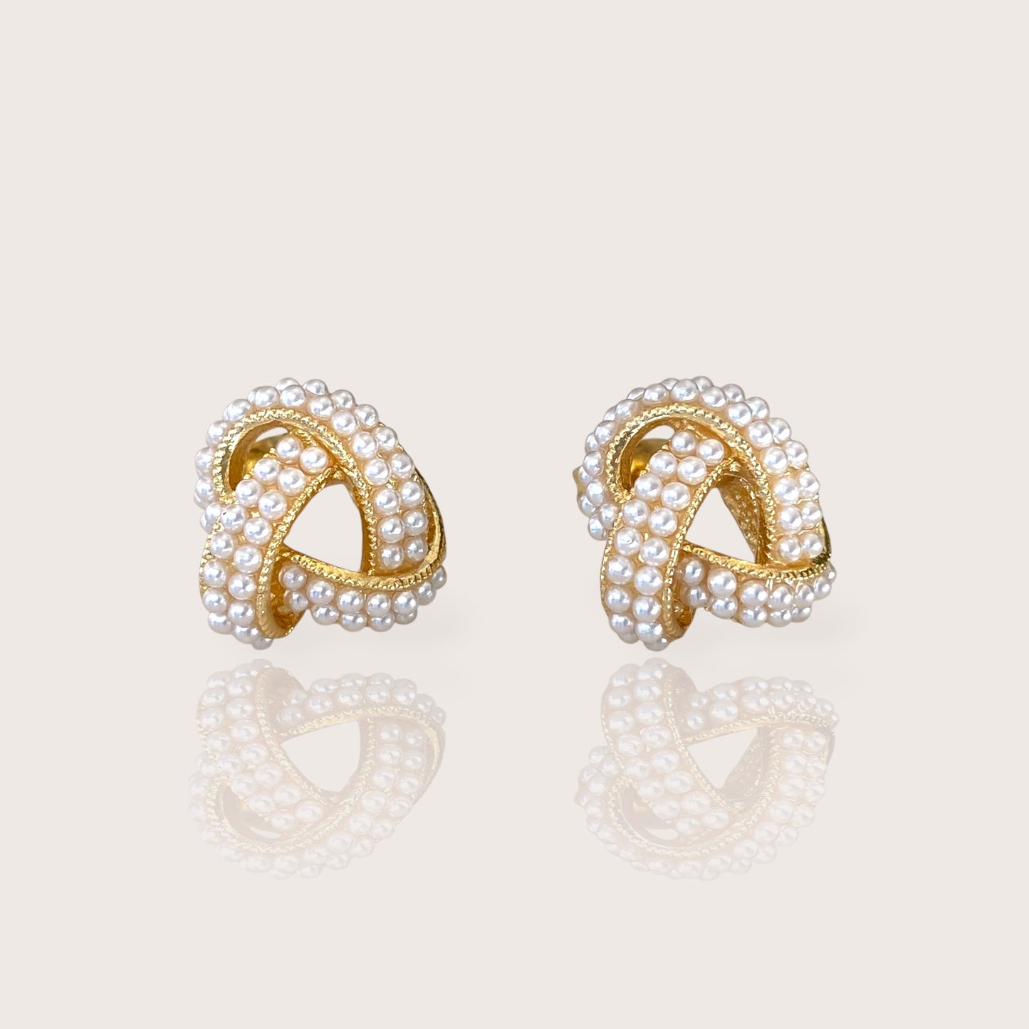 18K Gold Plated Pearl Cluster Love Knot Stud Earrings displaying the polished finish and beautiful ivory pearls.
