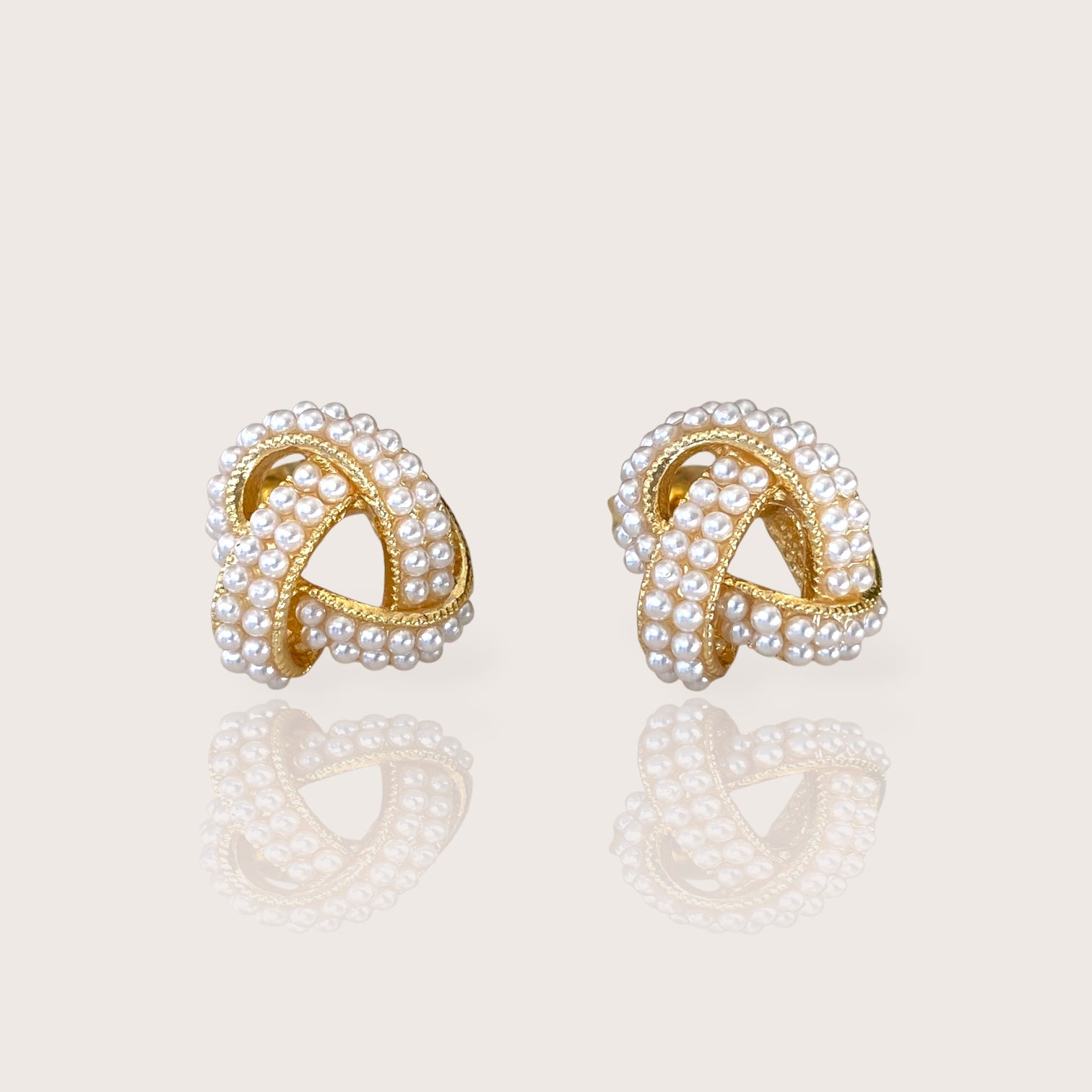 18K Gold Plated Pearl Cluster Love Knot Stud Earrings displaying the polished finish and beautiful ivory pearls.