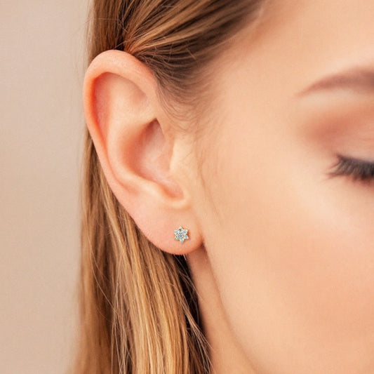 Dainty Diamond Flower Earrings in Solid 14K Gold shown on a model