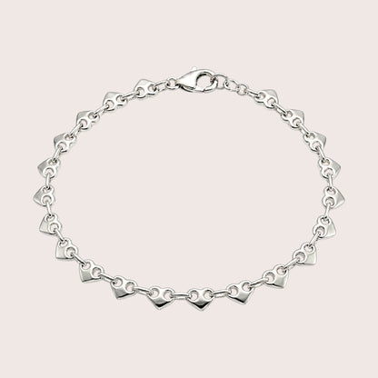 Delicate silver heart link bracelet arranged in an oval with a lobster clasp at the top.